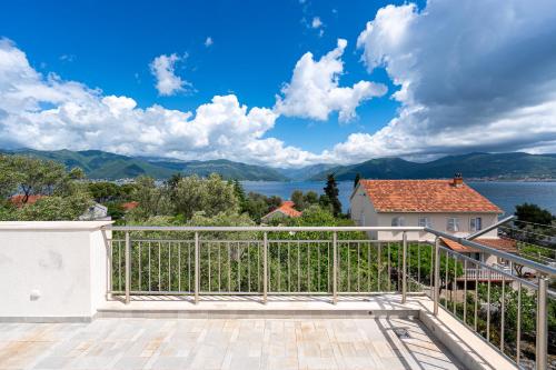 a balcony with a view of a lake and mountains at Simphony Apartments in Tivat