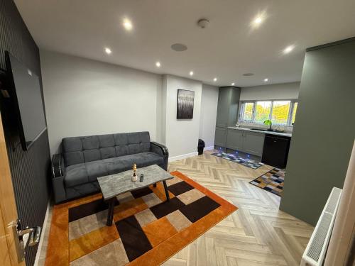 a living room with a couch and a table at Luxurious 3 bedrooms flat near New Cross,Wolverhampton No Parties or events in Wednesfield