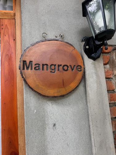 a sign that says mangrove on the side of a building at Steps Garden Resort in Negombo