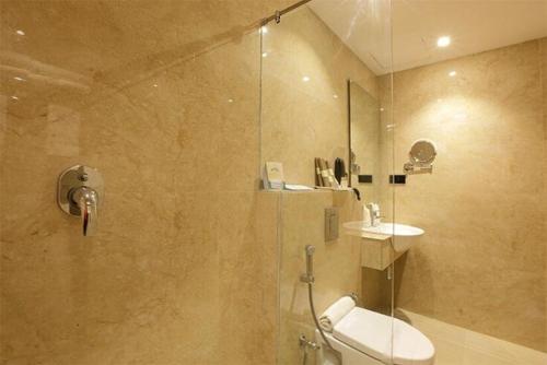 a bathroom with a shower with a toilet and a sink at Park Residency Kodungallur in Trichūr