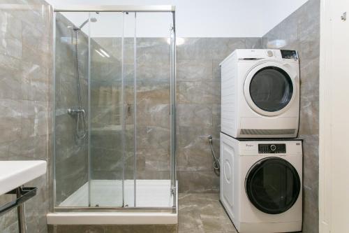 a washing machine and a washer in a bathroom at Spacious, Bright and Newly Renovated 2 Bedroom Apartment, Lisbon Historical Center, Madragoa in Lisbon