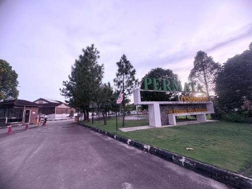 a sign for a pharmacy on the side of a street at HoMestaY Kulim Seri Rambai in Kulim