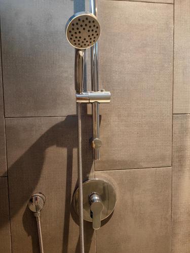 a shower head on the side of a wall at K Avenue Modern Style Studio (5 Mins to Airport) in Kota Kinabalu