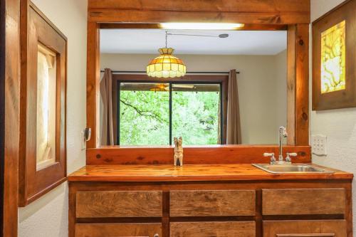 a bathroom with a sink and a mirror at Pecan Creek Cottage in Fourth Crossing