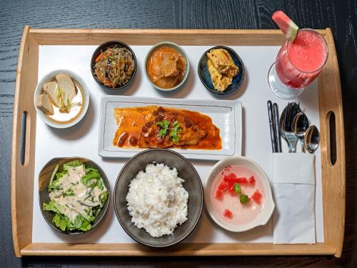 a tray of food with rice and different types of food at Tama Boutique Hotel in Bandung