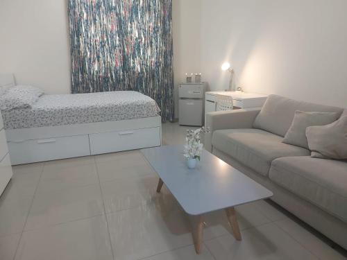 a living room with a couch and a bed at Good place for stay in Al Ain