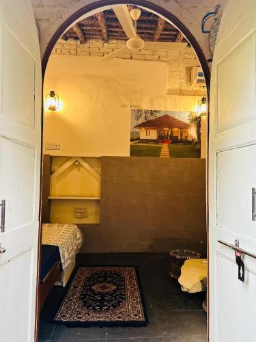 a room with a bed and a room with an archway at Travellers Village-City Center Hertige Home in Jaipur