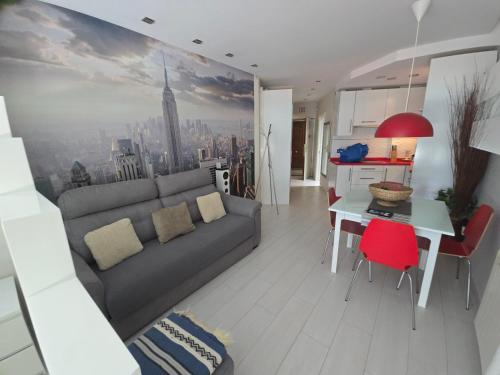 a living room with a couch and a table at Estudio I vistas mar, cerca tren y Malaga in Torremolinos