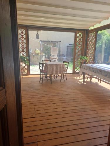 a screened in porch with a table and chairs at Sunshine Suites in Florence