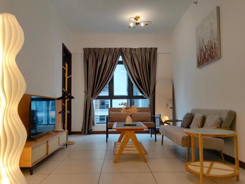 a living room with a couch and a tv at K Avenue Modern Style Studio (5 Mins to Airport) in Kota Kinabalu