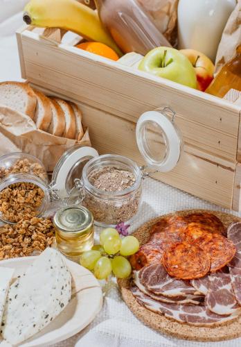 a table topped with different types of bread and fruit at Életem Vendégház in Esztergom