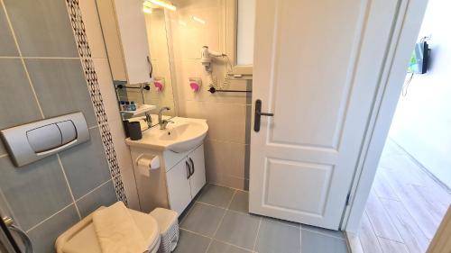 a bathroom with a toilet and a sink at Aphrodite Hotel Bozburun in Bozburun