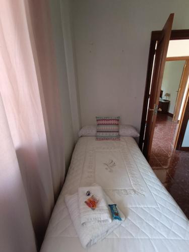 a small bed in a room with towels on it at Casa Rural Chalet Venta del Aire Cortijo Terron in Lanjarón