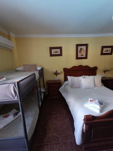 a bedroom with two bunk beds in a room at Casa Rural Chalet Venta del Aire Cortijo Terron in Lanjarón