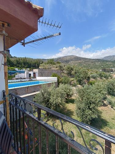 a view from the balcony of a house with a swimming pool at Casa Rural Chalet Venta del Aire Cortijo Terron in Lanjarón