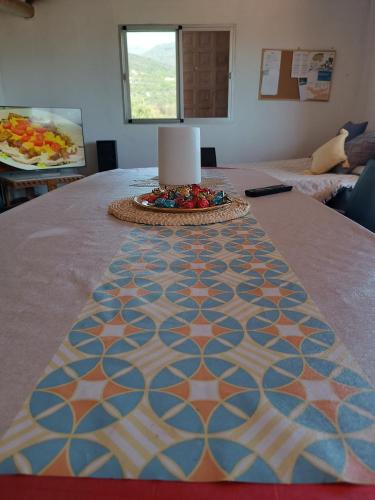 a table with a table cloth with a cake on it at Casa Rural Chalet Venta del Aire Cortijo Terron in Lanjarón