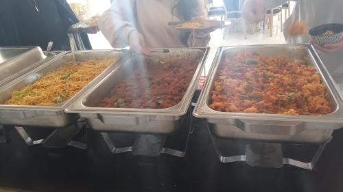 three trays of food on a counter in a kitchen at Hôtel et Restaurant ARIJ in Midelt