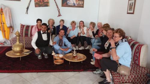 a group of people sitting on a couch at Hôtel et Restaurant ARIJ in Midelt