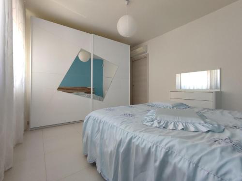 a bedroom with a bed and a painting on the wall at Casa Messina in Messina