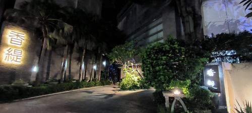 a building with lights on the side of it at night at Shantis Motel in Chiayi City