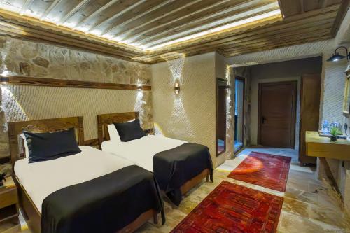 a hotel room with two beds in a room at Cappadocia ByHan Hotel - Special Class in Uchisar