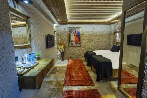a hotel room with a bed and a table at Cappadocia ByHan Hotel - Special Class in Uchisar