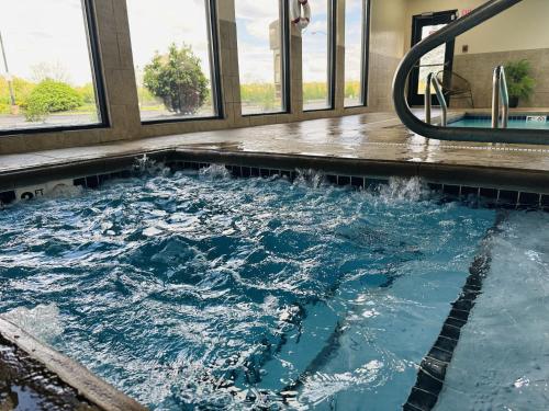 a large pool of water in a room with windows at Country Inn & Suites by Radisson, Canton near Hall of Fame in Canton