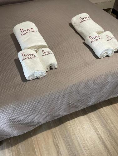 a bed with white towels on top of it at Marconi B&B - Holiday Home in Marconia