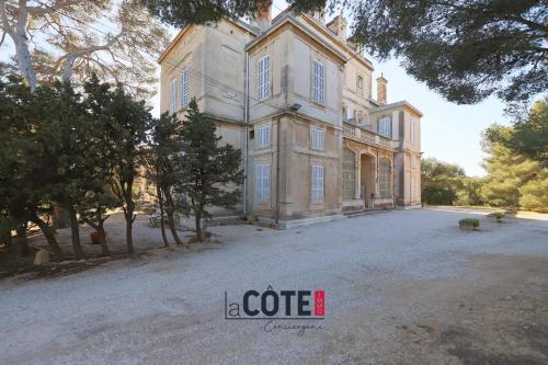 a large house with a large driveway in front of it at Château Charles Roux in Sausset-les-Pins