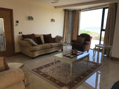 a living room with couches and a coffee table at Serene luxurious Retreat with Sea Views, Entire Home Letterkenny in Letterkenny
