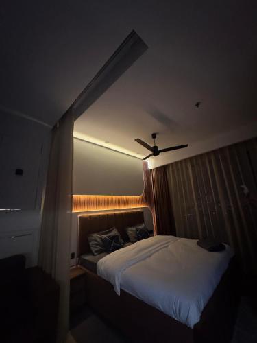a bedroom with a bed in a dark room at Luxurious studioz in New Delhi