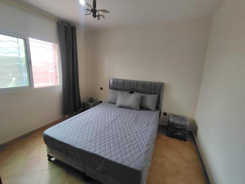 a bedroom with a bed and a window at Charming Apt Pool & Beach in Sidi Bouzid