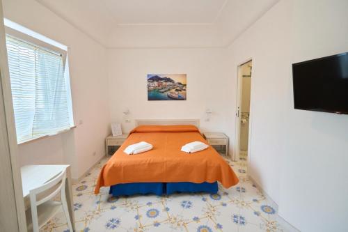 a bedroom with a bed and a flat screen tv at Casa Nannina in Anacapri