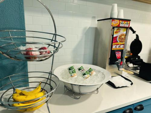 a counter top with two bowls and bananas on it at Country Inn & Suites by Radisson, Canton near Hall of Fame in Canton