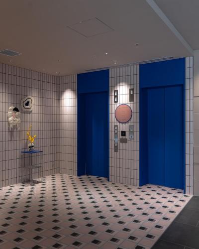 a room with two blue doors and a basketball on the wall at THE BASEMENT HOTEL OsakaHonmachi in Osaka