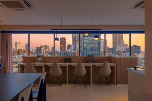 an office with a view of a city skyline at THE BASEMENT HOTEL OsakaHonmachi in Osaka