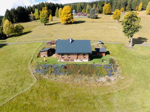 an aerial view of a small house in a field at Apartmán U Setra in Pec pod Sněžkou