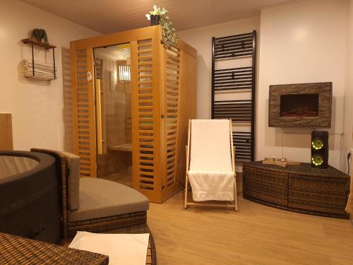 a living room with a couch and a chair at Studio Spa Sweet Nest jacuzzi-sauna-bazen in Otočac