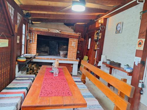 a wooden table in a room with a fireplace at Studio Spa Sweet Nest jacuzzi-sauna-bazen in Otočac