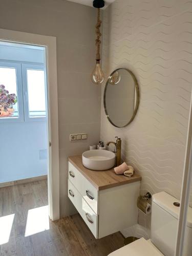 a white bathroom with a sink and a mirror at CASA NOAH in Nerja