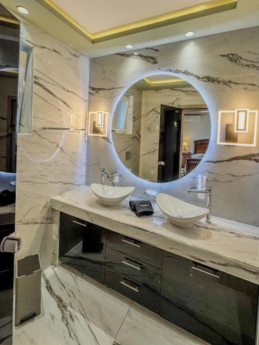 a bathroom with two sinks and a large mirror at GF Luxury Villa with indoor pool -Afytos in Afitos