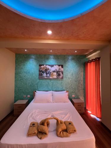 two teddy bears on a bed in a bedroom at Hotel Besa in Shëngjin