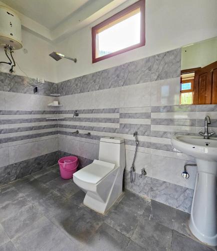 a bathroom with a toilet and a sink at The RAHIL's Kalga in Kalgha