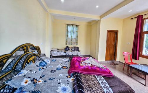 a large bed in a room with a table at The RAHIL's Kalga in Kalgha