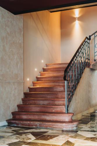 a staircase in a building with wooden steps at Casa D'Este - Hotel Ferrara in Ferrara