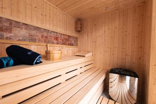 a wooden sauna with a bench in the middle at Motel Delphin in Pristina