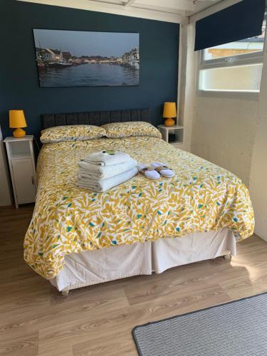 a bedroom with a bed with towels on it at The Haven garden room in Preston