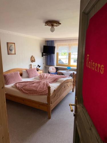 a bedroom with two beds and a red door at Häusl am Roan Reutte Höfen in Hofen