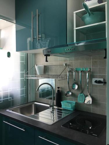 a kitchen with a sink and a counter top at White Turquoise -1 Bedroom Apartment- in Bangkok
