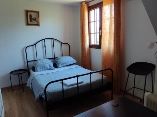 a bedroom with a bed and two stools at Chambre 2 en Pavillon BONNEUIL SUR MARNE in Bonneuil-sur-Marne